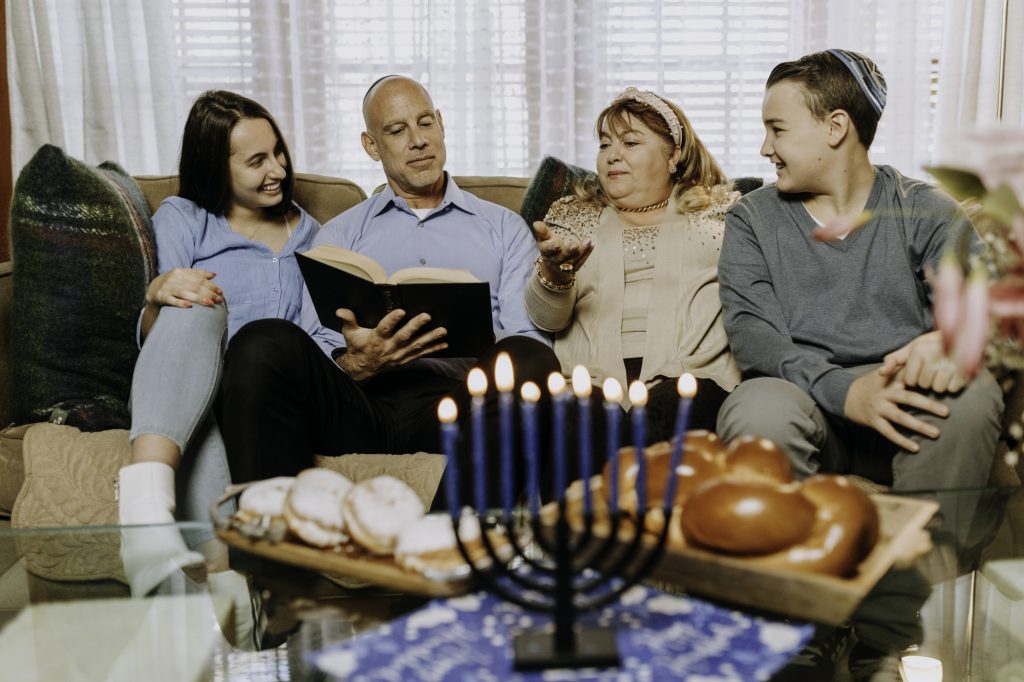 Photo Of Family Sitting On A Sofa