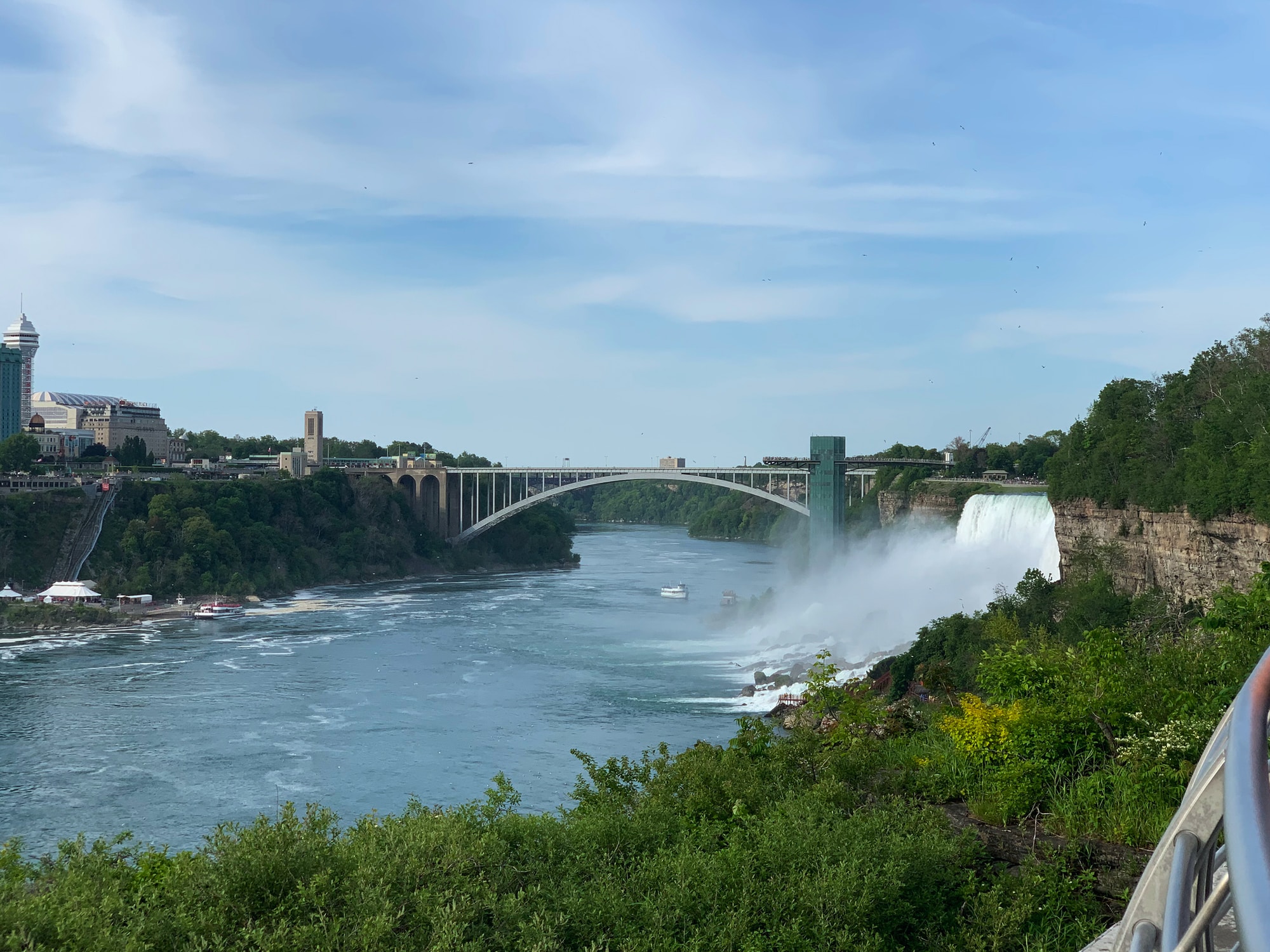 gray concrete bridge near waterfall